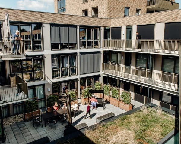 De binnentuin van Huis van Leusden, waar mensen samenkomen